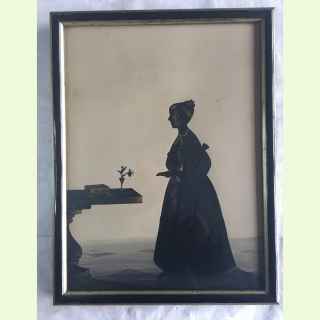 Georgian silhouetee portrait of a young girl atanding near a Georgian table decorated witn casket and vase of flowers