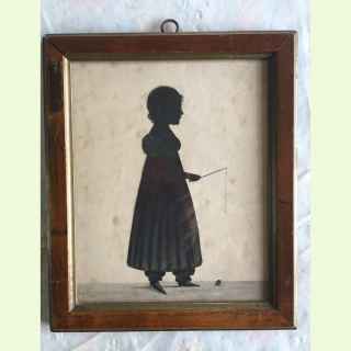 Silhouette portrait of a young girl in profile with a spinning top..